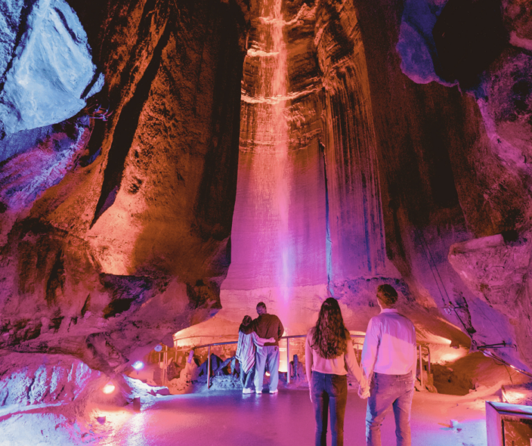 Two couples stand in front of Ruby Falls watefall inside the cave