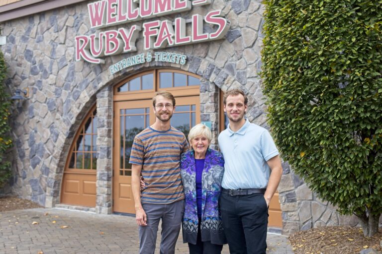 Mo Steiner stands between Ryan Davenport and Levi Kirk on the Village Plaza at Ruby Falls